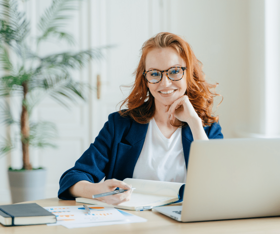 A person sitting at a desk, reflecting on their needs and priorities for setting boundaries