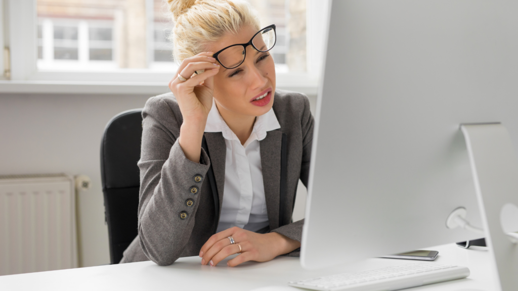 Person with a confused expression looking at a computer screen